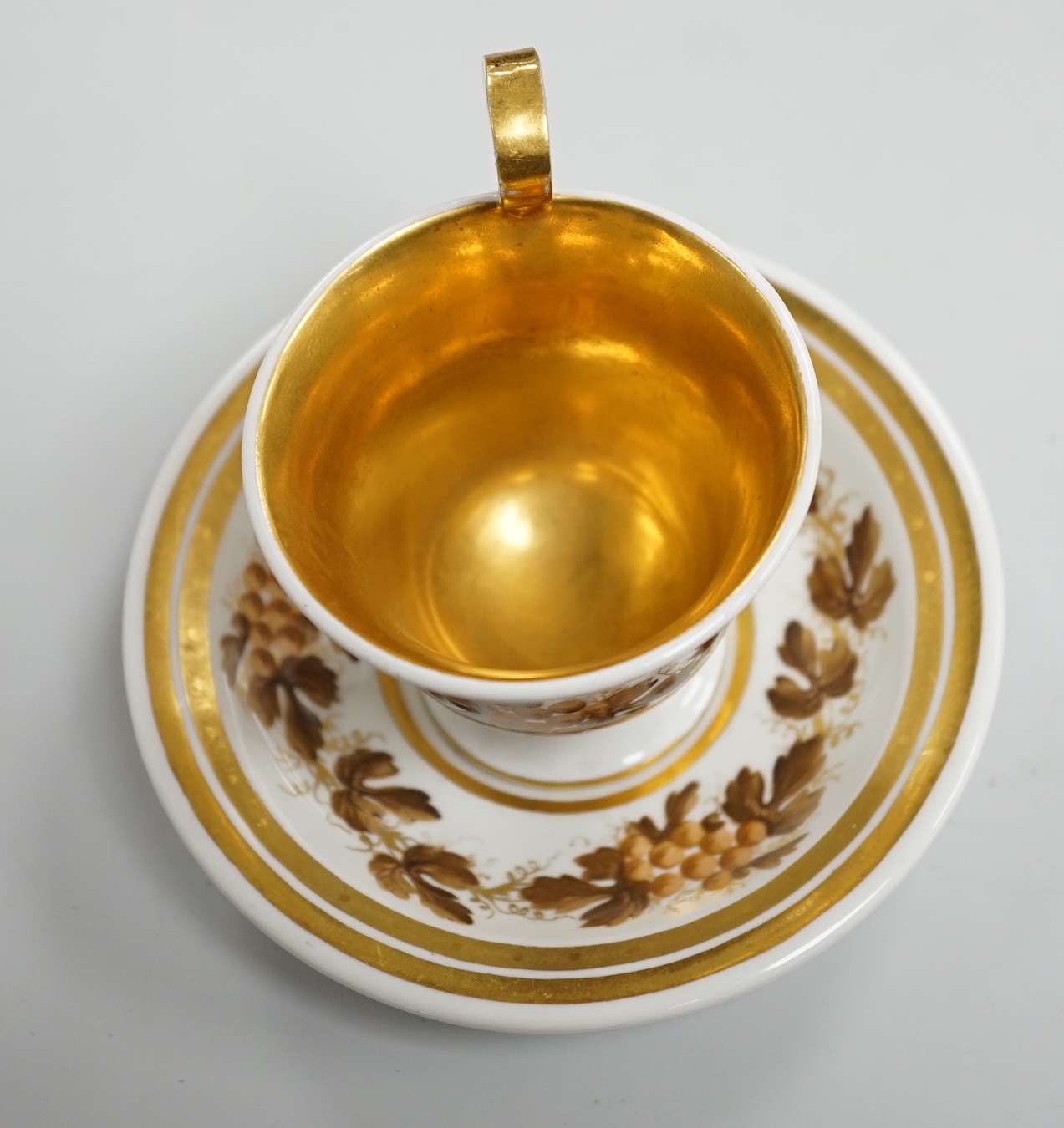 An early 19th century Furstenburg brown and white cup and saucer, saucer diameter 13cm